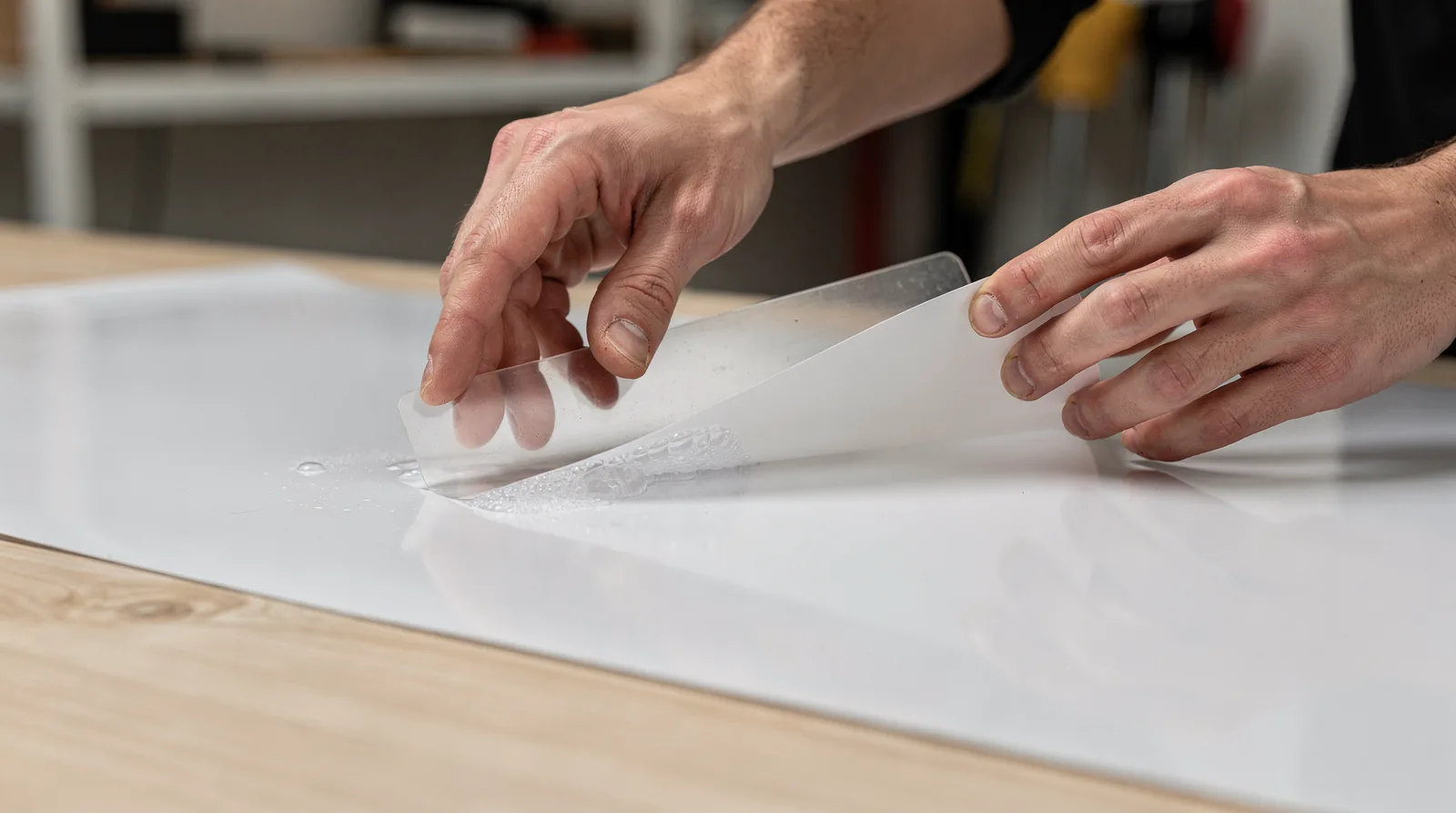 Applying decals without bubbles requires two critical steps: lubricating the adhesive side before placement